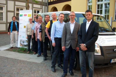 Sponsoren, Pfarrer und Gemeindefahrzeug